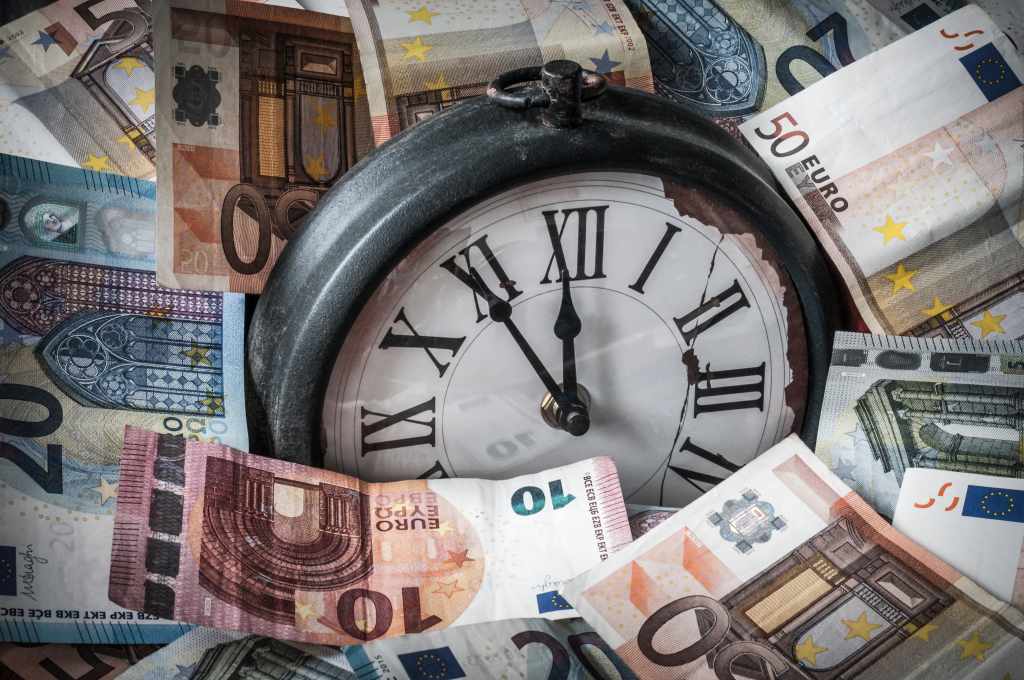 Geldscheine und eine Uhr als Zeichen für Gelderspranis durch digitale Zeiterfassung